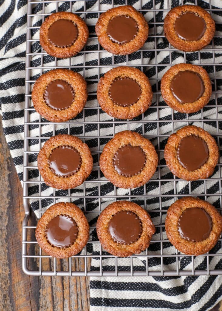 peanut butter cup filled peanut butter cookies on cooling rack