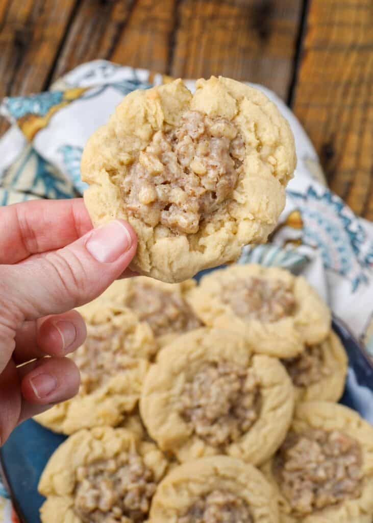 hand holding a holiday cookie with walnuts 