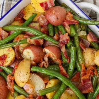 green beans and potatoes in white dish with blue rim