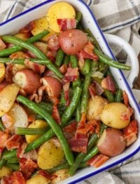 potatoes, green beans, and bacon in a square baking dish