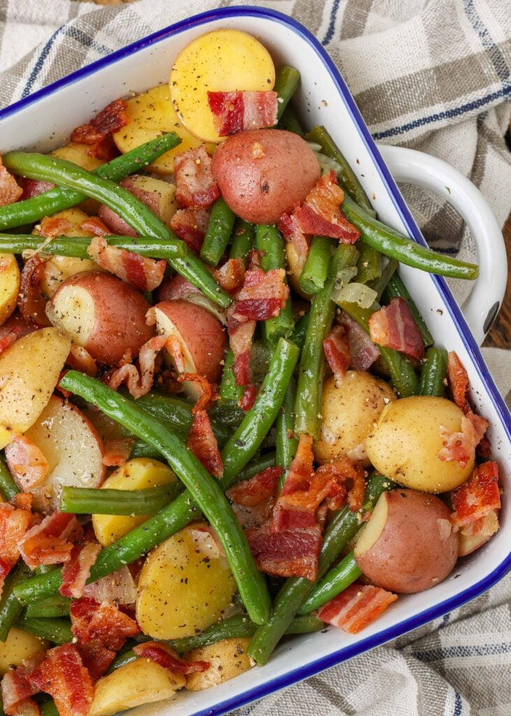 potatoes, green beans, and bacon in a square baking dish