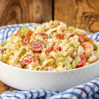 pasta salad in white bowl with blue towel
