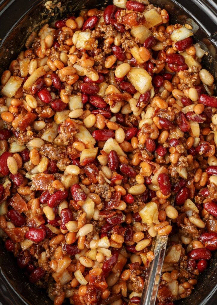 baked bean ingredients stirred together in the slow cooker