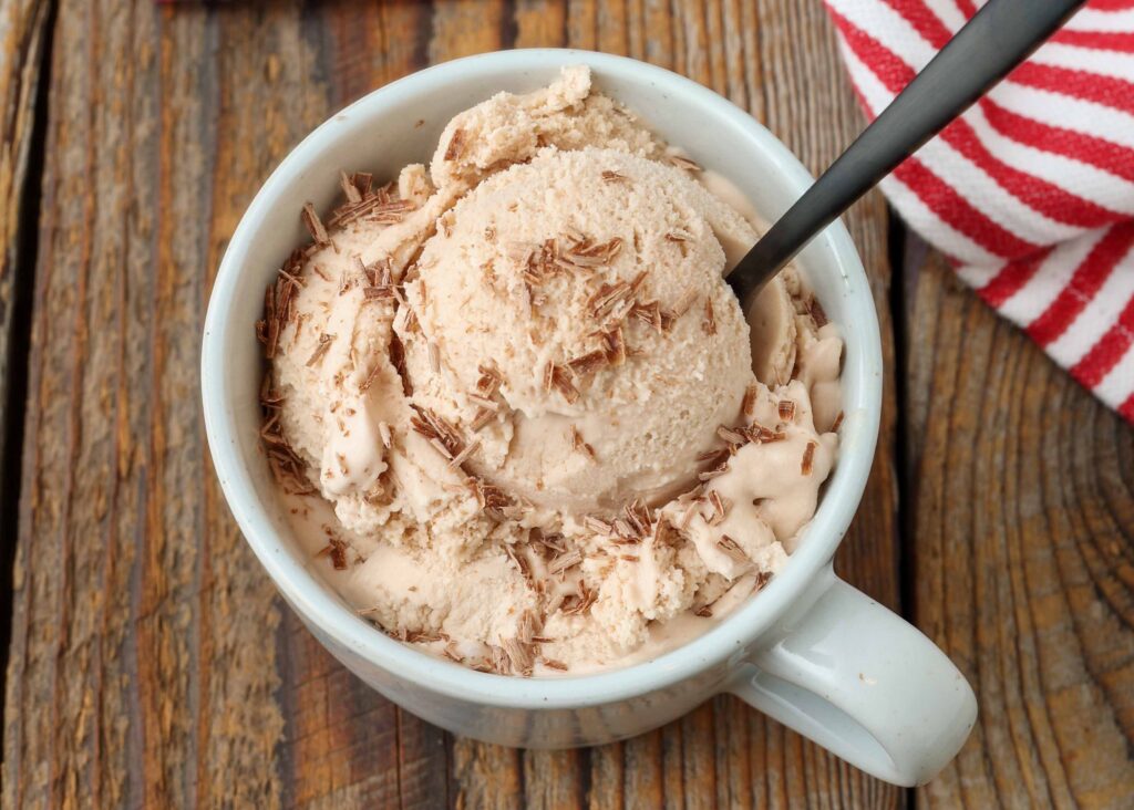 Peppermint mocha ice cream in a cup with a spoon