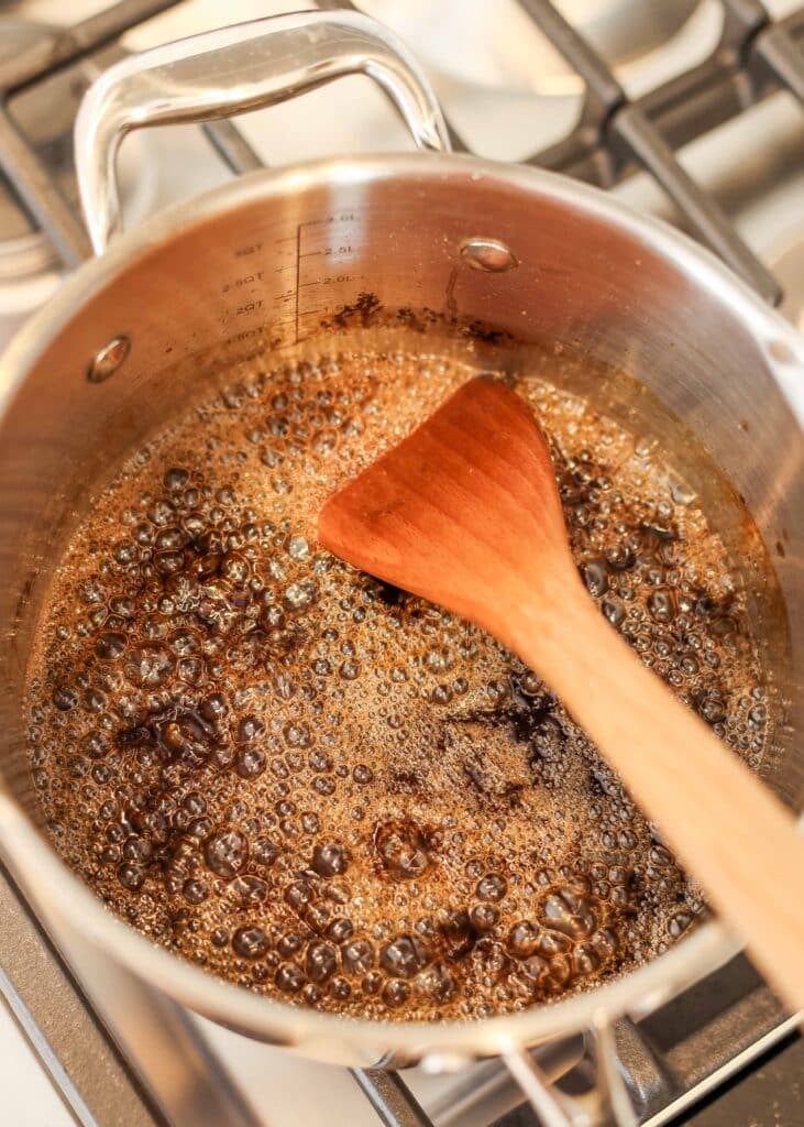 homemade syrup in pan on stove - starting to bubble and boil
