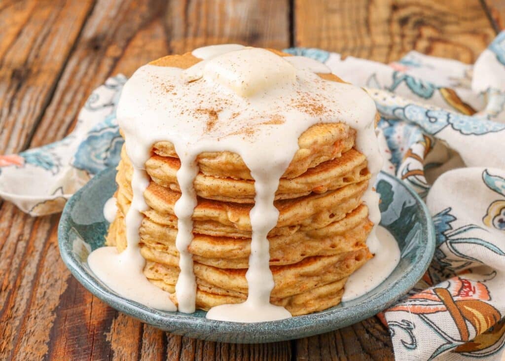 carrot cake pancakes stacked on blue plate