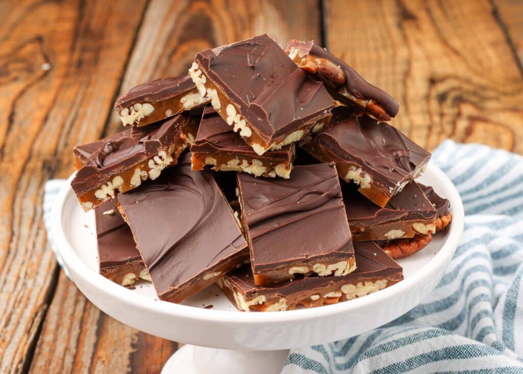 chocolate turtle bark stacked on white platter