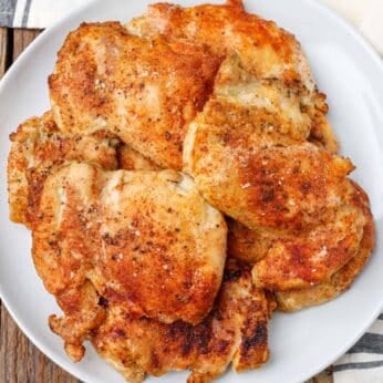 chicken thighs on round plate with towel