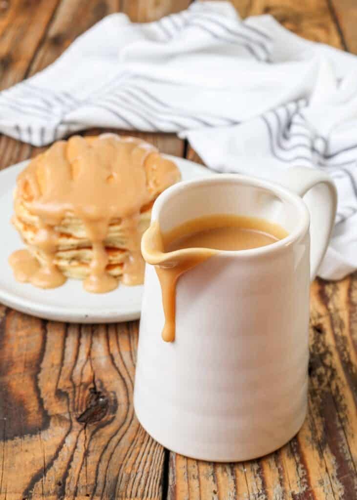 Creamy peanut butter syrup in a small white pitcher