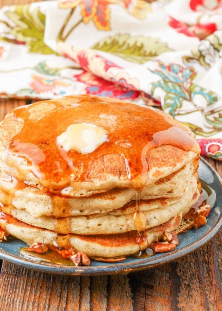 pancakes stacked with syrup poured over them