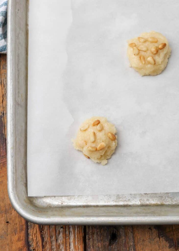 pine nut cookie dough on parchment lined tray