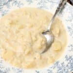 potato soup in blue bowl with spoon and napkin