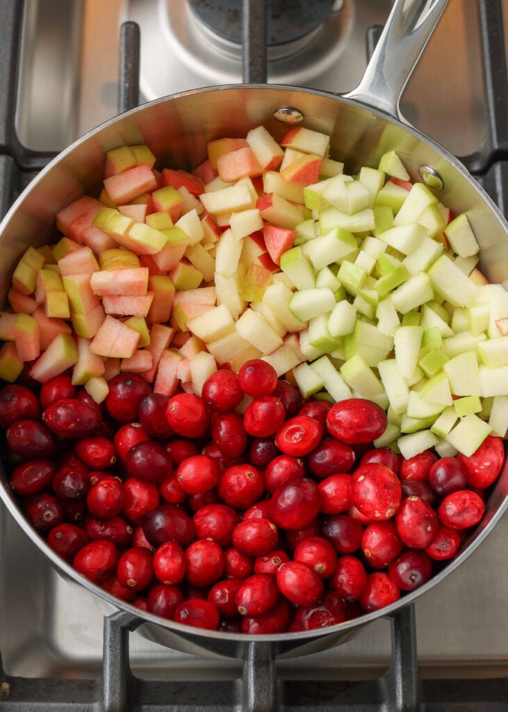 cranberries and apples in saucepan