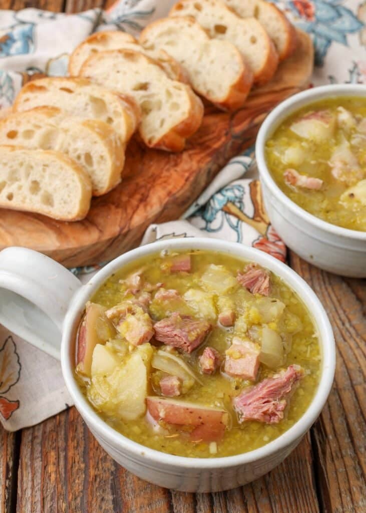 ham and potato split pea soup in white bowls