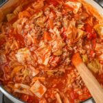 Cabbage Roll Soup with wooden spoon in white pot