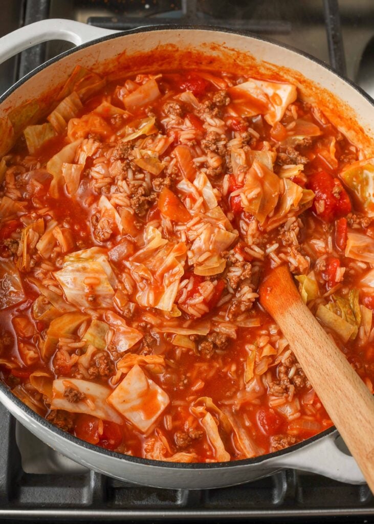 Cabbage Roll Soup with wooden spoon in white pot