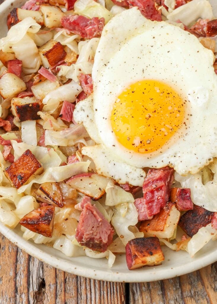 close up photo of Corned Beef Hash topped with an egg