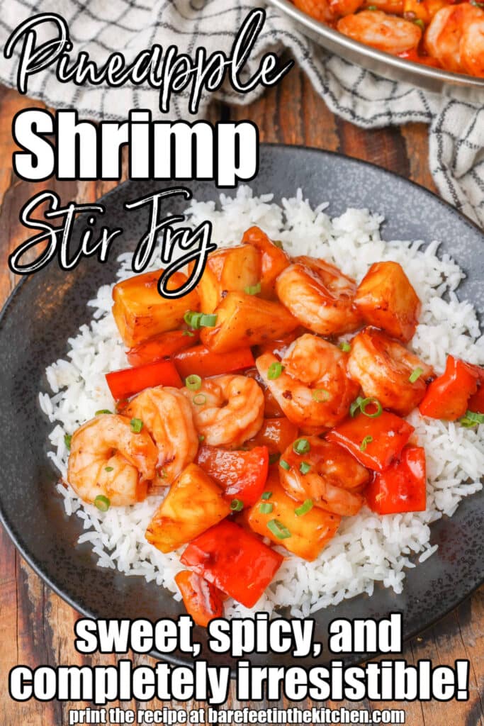 Stir-fried shrimp and peppers on a black plate over rice