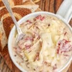 Creamy Reuben Soup in pottery mug with toasted rye bread