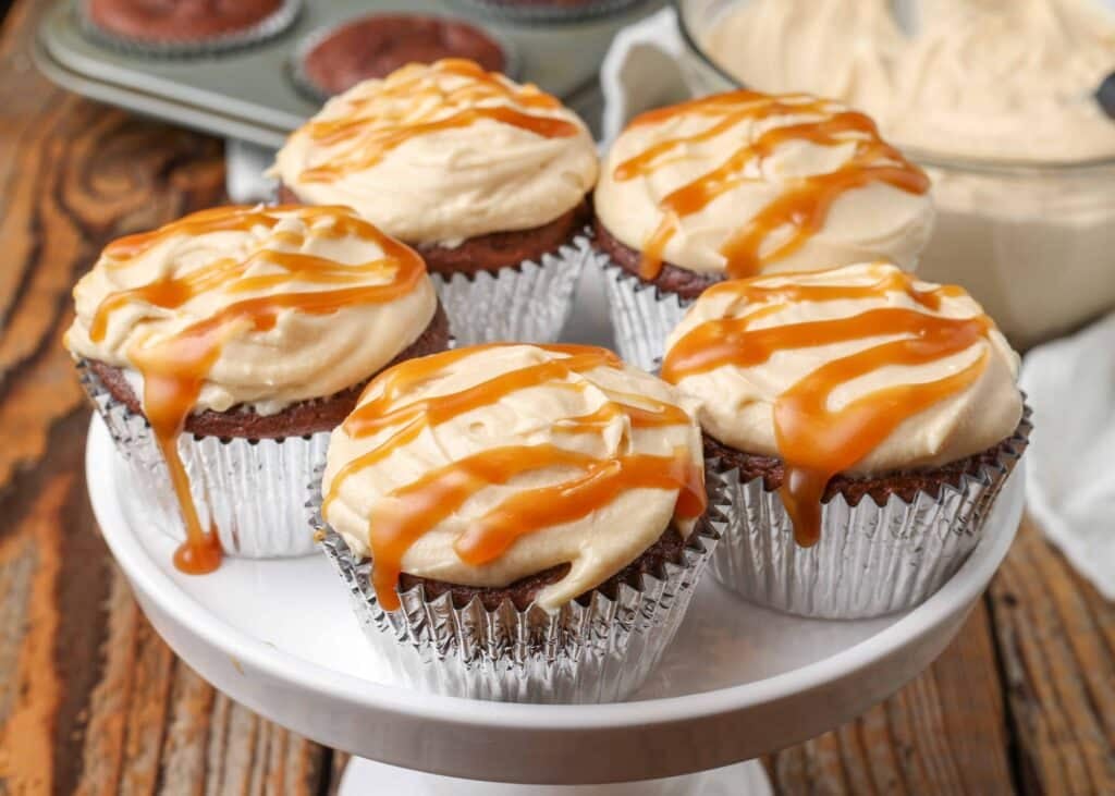 chocolate cupcakes with frosting and caramel sauce