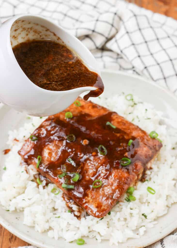 Balsamic Ginger Salmon with glaze pouring over rice