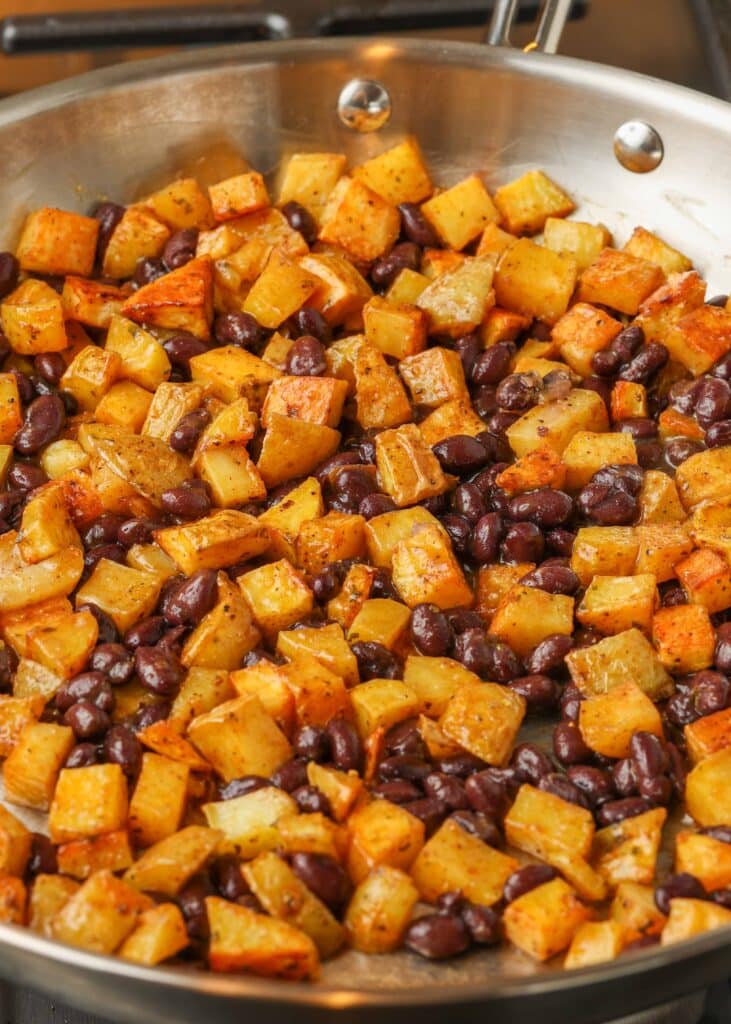Potatoes with black beans in a metal pan