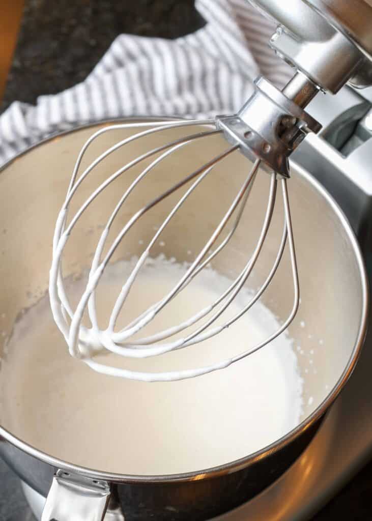 Fresh cream in mixer bowl with whisk