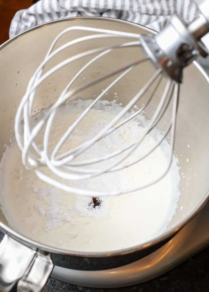 Cream with sugar and vanilla in a bowl