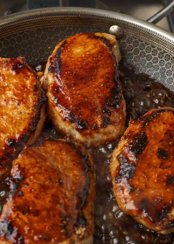 pork chops in skillet with balsamic glaze