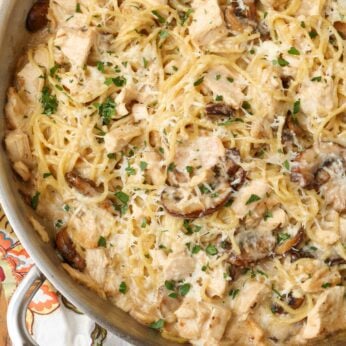 Chicken tetrazzini in large stainless pan on floral towel