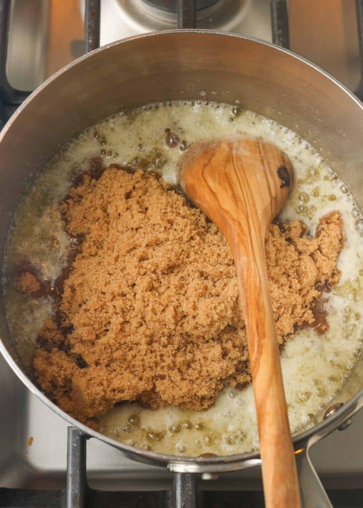 butter and brown sugar in saucepan with wooden spoon
