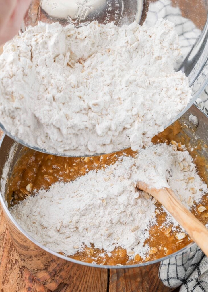 flour and oats being added to liquid ingredients