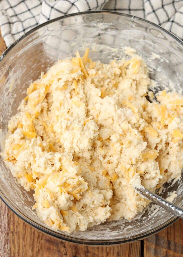 Cheddar drop biscuit dough in a bowl with a fork