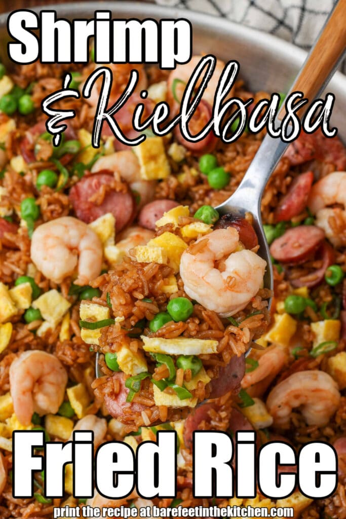 Sausage fried rice with shrimp in pan with serving spoon