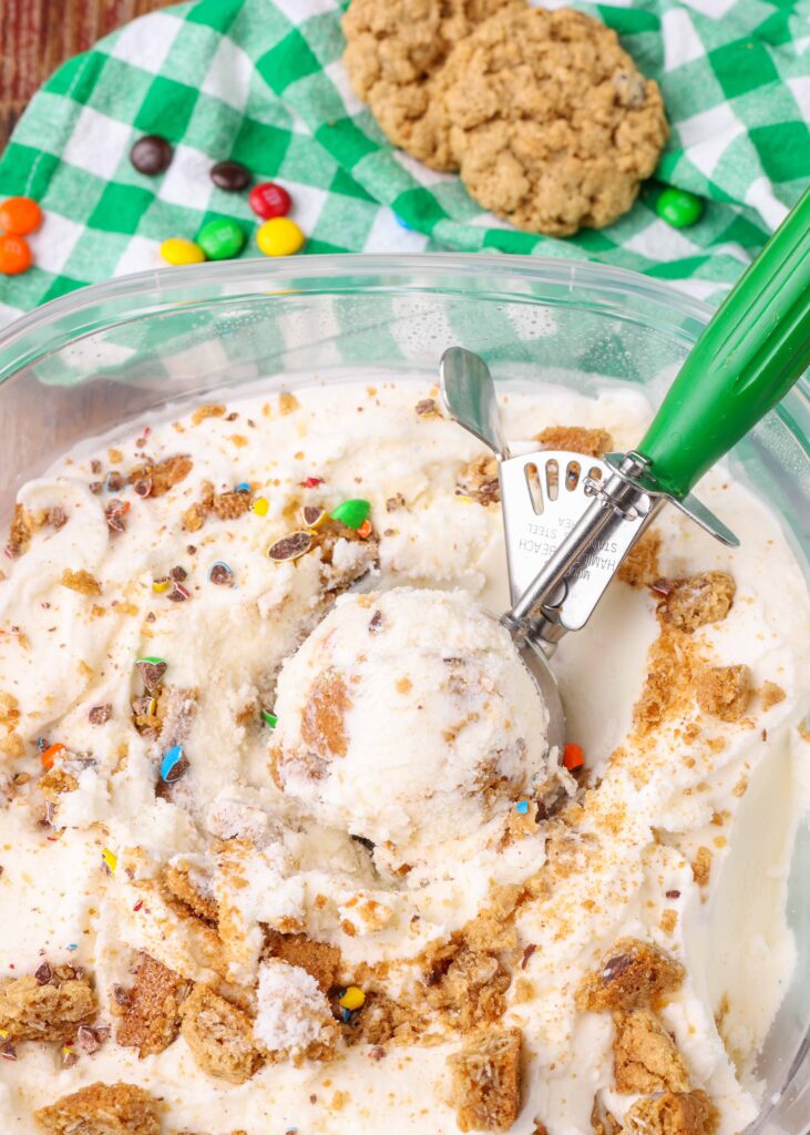 Ice cream with Monster Cookies in container with scoop