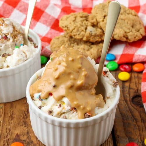 peanut butter sauce poured over ice cream with cookies in background