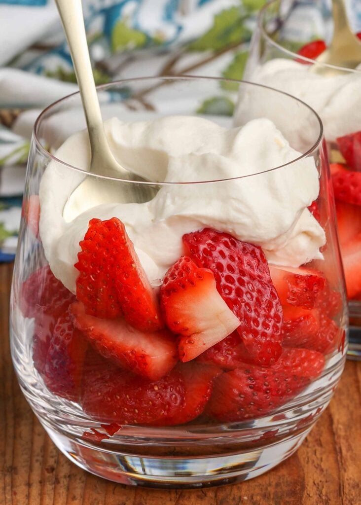 fresh berries in clear glass with whipped cream Romanoff sauce