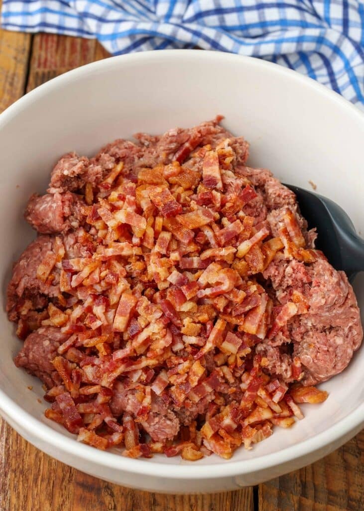 ground beef and bacon in large mixing bowl for meatloaf