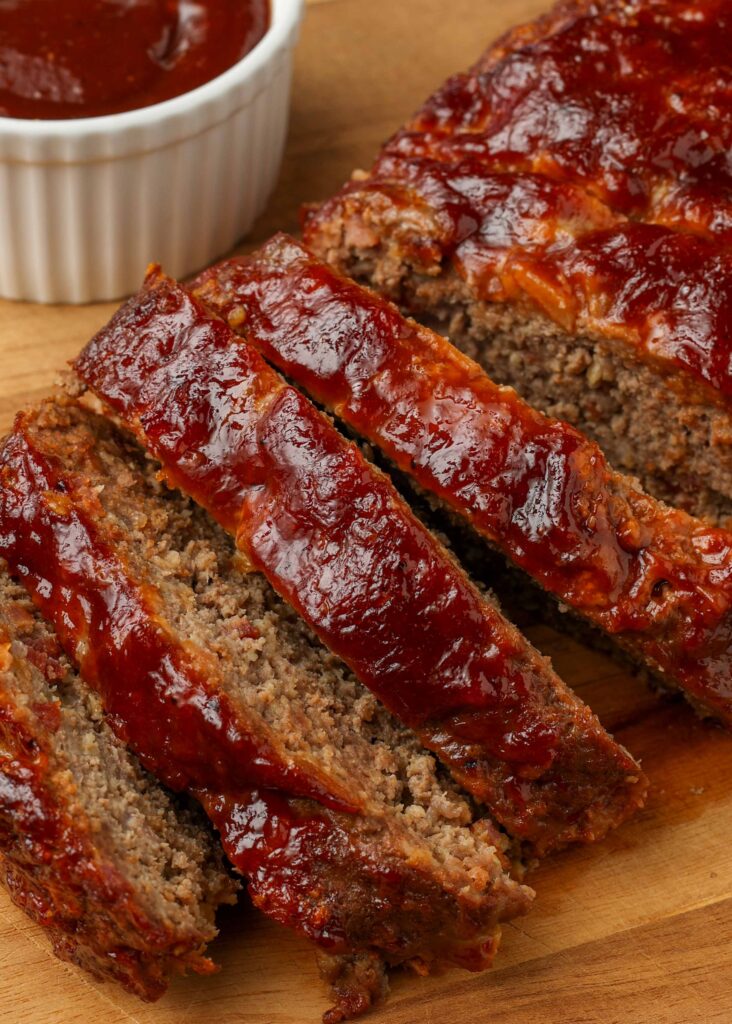 sliced meatloaf with BBQ sauce for dipping on the side