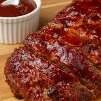 close up photo of meatloaf with bbq sauce and bacon