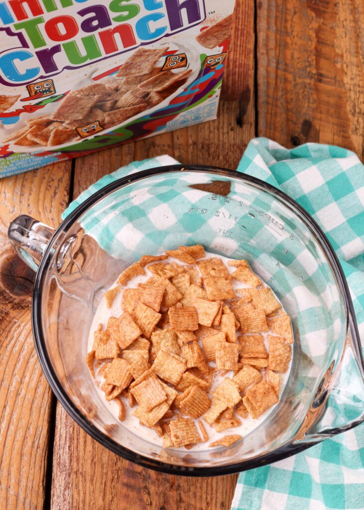 cereal steeps in the milk used to make this ice cream recipe within a clear glass pyrex measuring cup