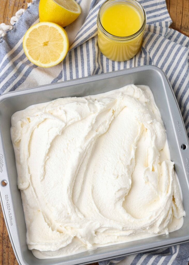 vanilla ice cream swirled with lemon curd has been placed in an 8x8 metal pan