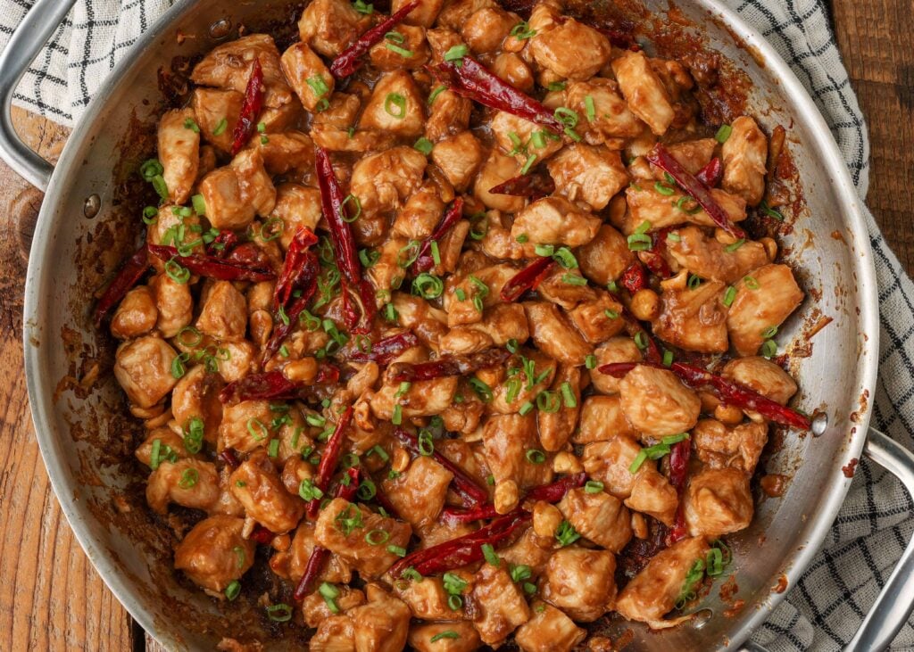 close up of kung pao chicken stir fry in large stainless skillet