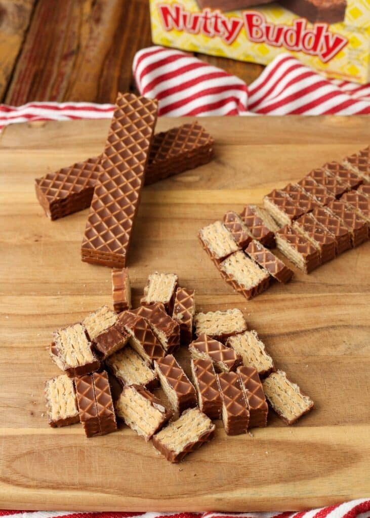 nutty buddy bars have been chopped on a wooden cutting board in this image