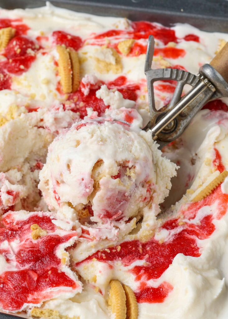 close up photo of strawberry shortcake ice cream in scoop