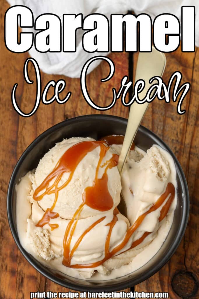 ice cream with salted caramel in black bowl with spoon on wooden table