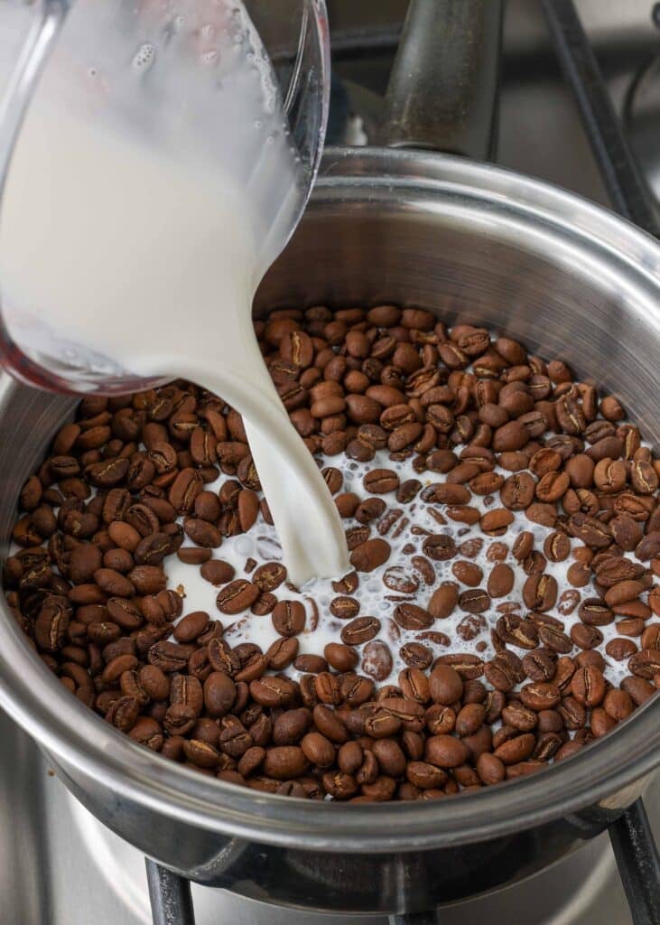 Overhead shot of coffee beans and milk in a sauce pan