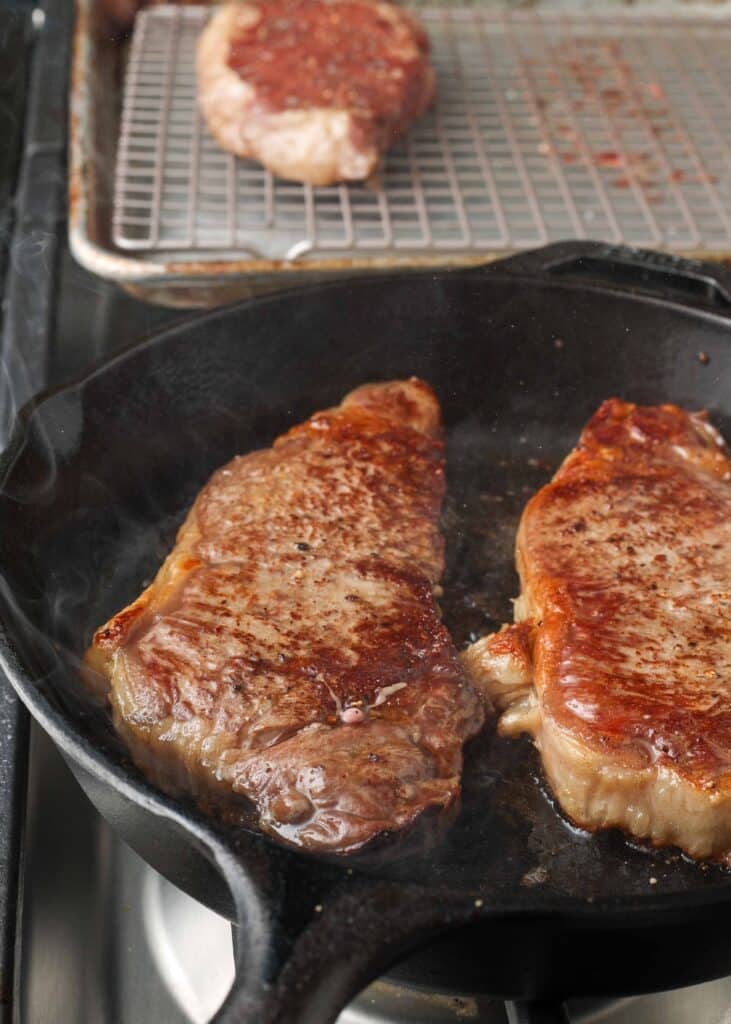 reverse seared NY strip steak in skillet