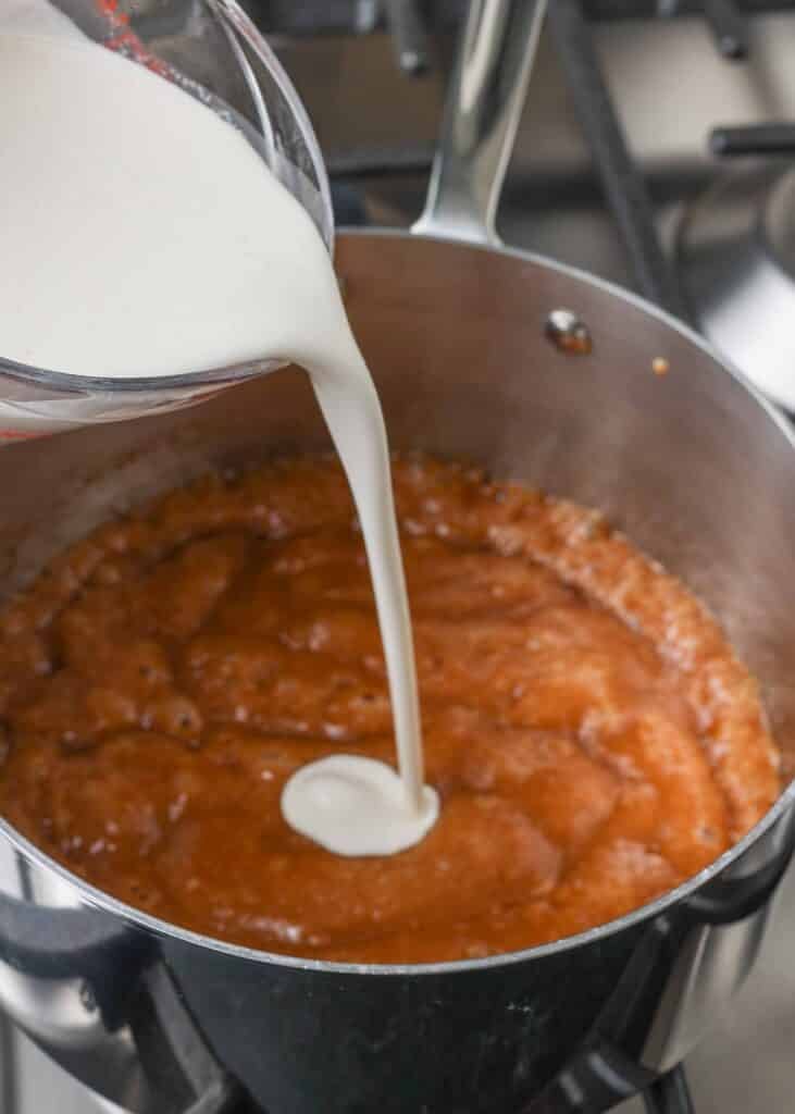 Cream being poured into caramel base for homemade ice cream