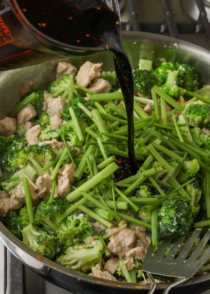 Pour stir-fry sauce over the vegetables in the pan